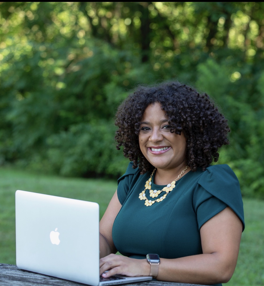 Segann March working at her laptop outdoors